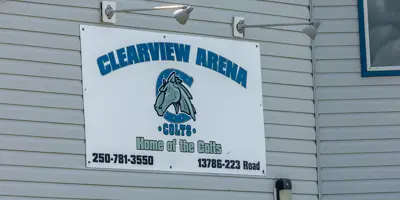 Exterior view of the sign on the Clearview Arena in Goodlow, British Columbia. The text reads 'Home of the Colts' with an illustrated horse.