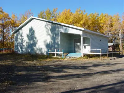 A picture of the Jackfish Community Hall in Electoral Area E of the Peace River Regional District, on a sunny fall day.