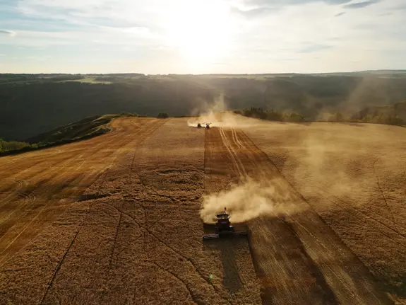 An aerial shot of machines harvesting a field