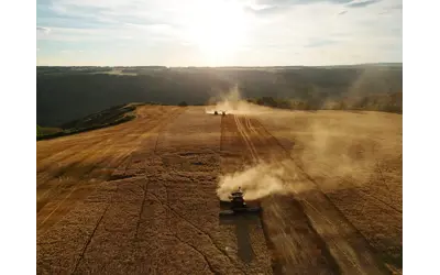 An aerial shot of machines harvesting a field
