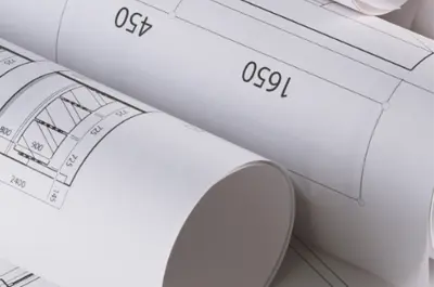 A close up of construction blueprints rolled up