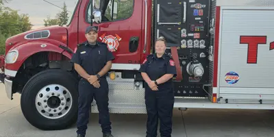 Lt. Chris Pelley and Lt. Miranda Moineau stand with Tactical Tender 1 prior to deploying to the Merritt area in support of BC Wildfire Service response efforts