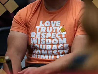 Promotional image for Moose Hide Campaign Day, May 14, 2026. A person in an orange shirt featuring the Seven Sacred Teachings (Love, Truth, Respect, Wisdom, Courage, Honesty, Humility) wears a square of moose hide. The graphic includes the campaign logo and the registration website: moosehidecampaign.ca.